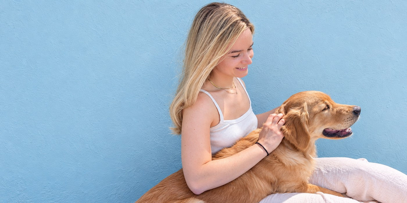 Lucy sitting with Colin against a pale Sky wall